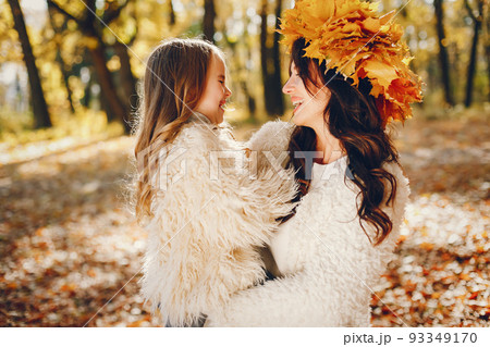 Beautiful mother with daughter. Family in a autumn park. Golden autumn 93349170