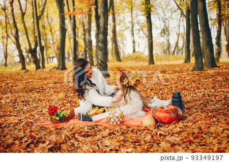 Beautiful mother with daughter. Family in a autumn park. Golden autumn Beautiful mother with daughter. Family in a autumn park. Golden autumn 93349197