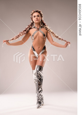 Seductive woman in futuristic underwear touching braids 93349508
