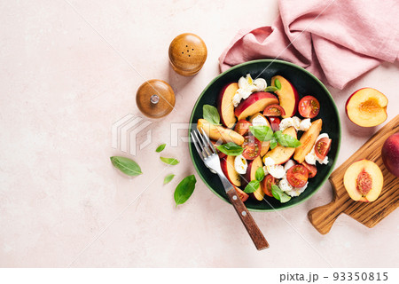 Salad with peach, mozzarella cheese and tomatoes Salad with peach, mozzarella cheese and tomatoes 93350815