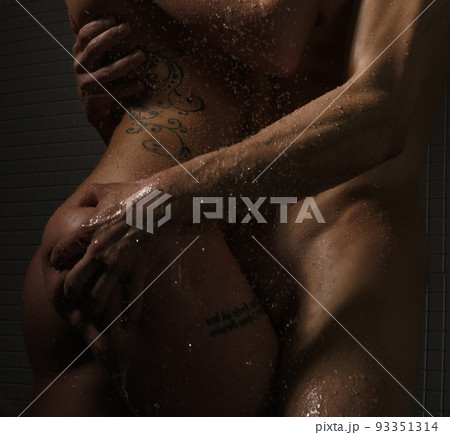 Passionate couple posing in shower studio shot 93351314