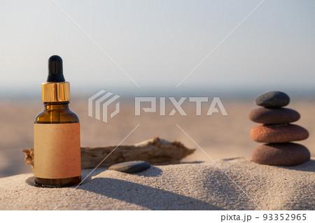 Bottle with beachfront drippers, natural composition. Mockup organic natural cosmetic product. Zen stone and brow bottle. Bottle with beachfront drippers, natural composition. Mockup organic natural cosmetic product. Zen stone and brow bottle. 93352965