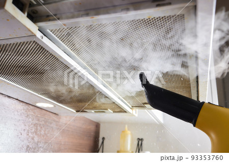 house cleaning. Girl brushes steam cleaners kitchen drawing with steam in green gloves. cleaning of a surface. house cleaning. Girl brushes steam cleaners kitchen drawing with steam in green gloves. cleaning of a surface. 93353760