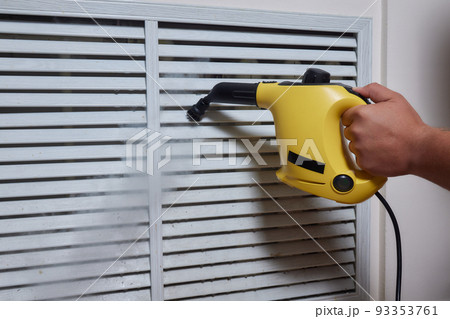 Cleaning company. girl with a steam cleaner brushing the home battery. We begin cleaning of the apartment. House worker. Leisure in gloves. We kill microbes and rust. 93353761