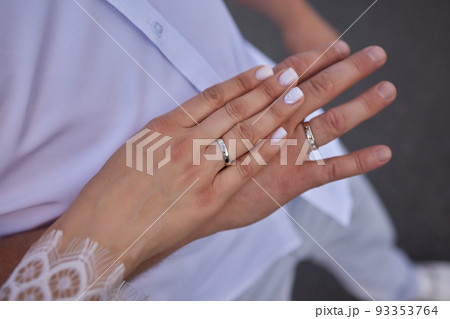 Newly wed couple's hands with wedding rings. 93353764