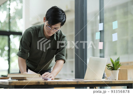Young asian business man or student working online on computer laptop. Young asian business man or student working online on computer laptop. 93356878