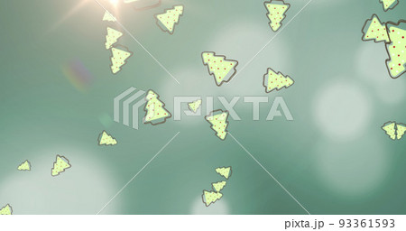 Image of christmas trees over lights and green background 93361593