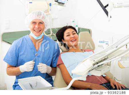 Woman is sitting satisfied in chair after treatment in dental clinic 93362186