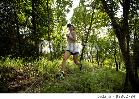 Woman runner running on forest trail 93362734