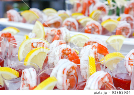 Boiled shrimp with lemon beside before appetizer. 93365934