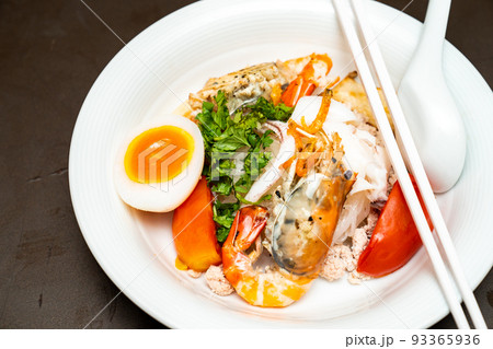 Seafood Thai noodle mixxed together between boiled shrimp, squid, pork, egg and colourful vegetable in white bowl. Seafood Thai noodle mixxed together between boiled shrimp, squid, pork, egg and colourful vegetable in white bowl. 93365936