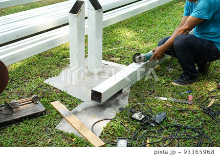 Asian smith are sawing the steel pole. Asian smith are sawing the steel pole. 93365968