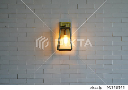 Square steel lamp tungsten/warm light on the white brick wall. 93366566