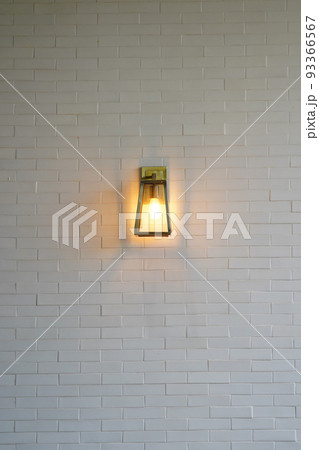 Square steel lamp tungsten/warm light on the white brick wall. 93366567