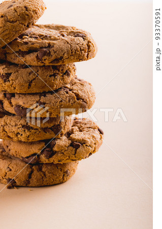 Close-up of stack of cookies on beige background with copy space Close-up of stack of cookies on beige background with copy space 93370591