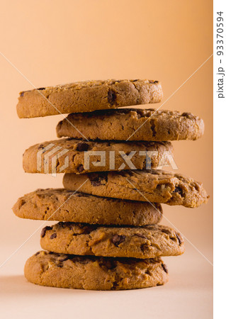Close-up of stacked cookies against brown background, copy space Close-up of stacked cookies against brown background, copy space 93370594