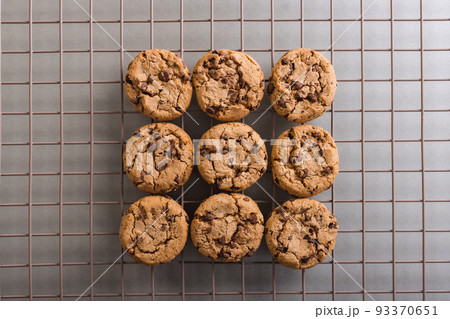 Directly above view of fresh cookies on cooling rack at table, copy space 93370651