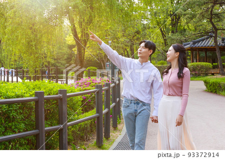 Korean Asian couple enjoying spring date_holding hands 93372914