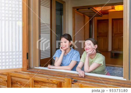 Experience Hanok, Korean traditional house_Korean and Caucasian girls looking outside the window Experience Hanok, Korean traditional house_Korean and Caucasian girls looking outside the window 93373180