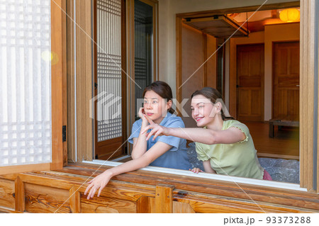 Experience Hanok, Korean traditional house_Korean and Caucasian girls looking outside the window 93373288