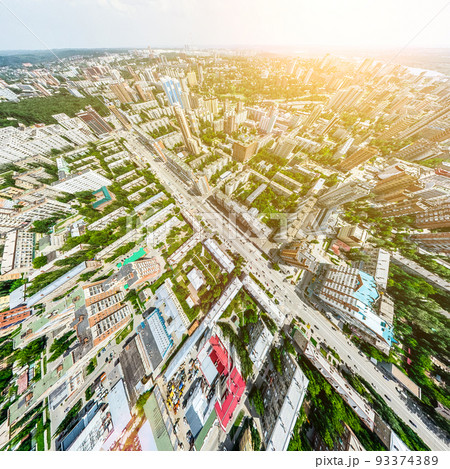 Aerial city view with crossroads and roads, houses, buildings, parks and parking lots. Sunny summer panoramic image 93374389