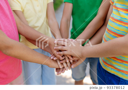 Children standing in circle with palms outstretched 93378012
