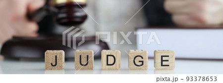 Male judge in courtroom hits with gavel and clenches fist Male judge in courtroom hits with gavel and clenches fist 93378653