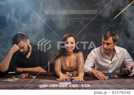 Group of a young rich friends are playing poker in casino. 93379346