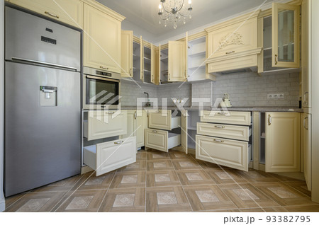 Interior of modern trendy cream colored kitchen Interior of modern trendy cream colored kitchen 93382795