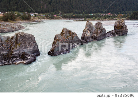 A fast-flowing wide and full-flowing mountain river. A fast-flowing wide and full-flowing mountain river. 93385096