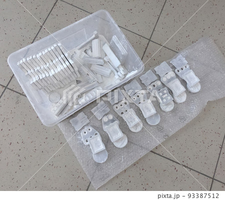 Detail objects printed on powder 3D printer and covered white polyamide powder close-up. Technology Multi Jet Fusion MJF. 3D prototype models created by new additive progressive 3d printing technology Detail objects printed on powder 3D printer and covered white polyamide powder close-up. Technology Multi Jet Fusion MJF. 3D prototype models created by new additive progressive 3d printing technology 93387512