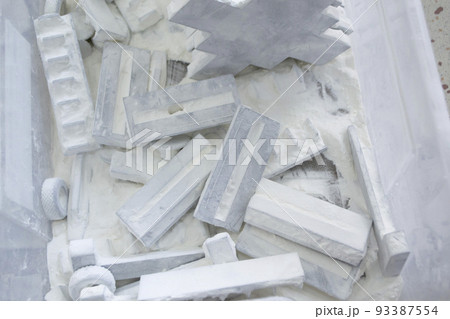 Detail objects printed on powder 3D printer and covered white polyamide powder close-up. Technology Multi Jet Fusion MJF. 3D prototype models created by new additive progressive 3d printing technology Detail objects printed on powder 3D printer and covered white polyamide powder close-up. Technology Multi Jet Fusion MJF. 3D prototype models created by new additive progressive 3d printing technology 93387554