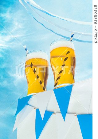 Glasses of cold frothy light beer over summer blue sky background. Vacation, happiness, Oktoberfest vibes and ad concept. Retro style Glasses of cold frothy light beer over summer blue sky background. Vacation, happiness, Oktoberfest vibes and ad concept. Retro style 93390329