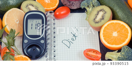Glucose meter for checking sugar level, notepad and fruits with vegetables containing vitamins Glucose meter for checking sugar level, notepad and fruits with vegetables containing vitamins 93390515