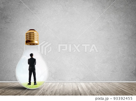Businessman trapped in bulb 93392455