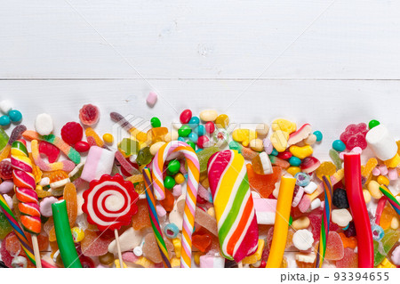 Colorful candies on wooden background 93394655