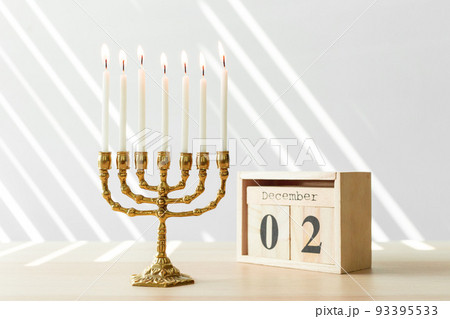 Bronze Hanukkah menorah with burning candles 93395533