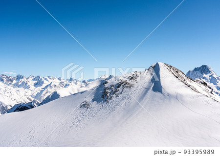 Panorama of winter snowy mountains in Caucasus region, Russia 93395989