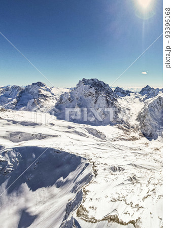 snowy mountains and snow under the sun  93396168