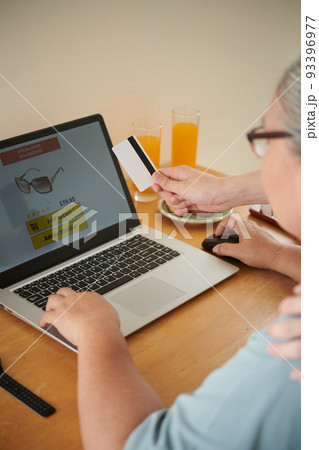 Grandson paying for purchases his grandmother makes online Grandson paying for purchases his grandmother makes online 93396977