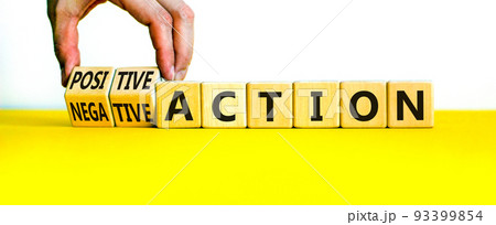 Positive or negative action symbol. Businessman turns cubes and changes words negative action to positive action. Beautiful white background, copy space. Business positive or negative action concept. 93399854