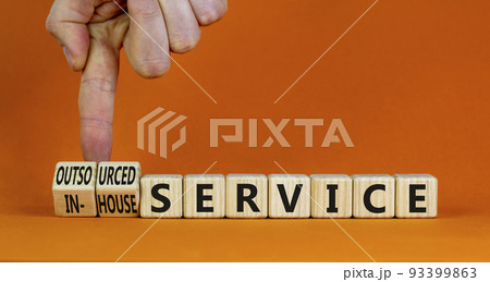 In-house or outsourced service symbol. Businessman turns cubes and changes words In-house service to Outsourced service. Orange background. Business In-house or outsourced service concept, copy space. In-house or outsourced service symbol. Businessman turns cubes and changes words In-house service to Outsourced service. Orange background. Business In-house or outsourced service concept, copy space. 93399863
