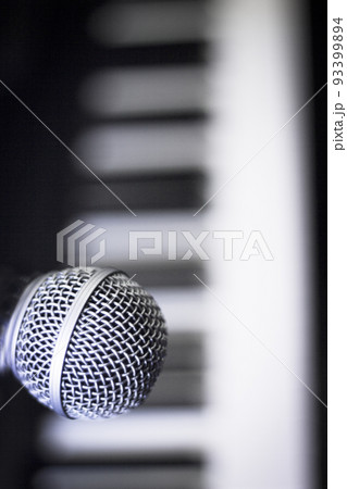 Microphone over piano keys in dim light Microphone over piano keys in dim light 93399894