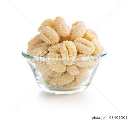 Uncooked potato gnocchi in bowl isolated on white background. Uncooked potato gnocchi in bowl isolated on white background. 93401501