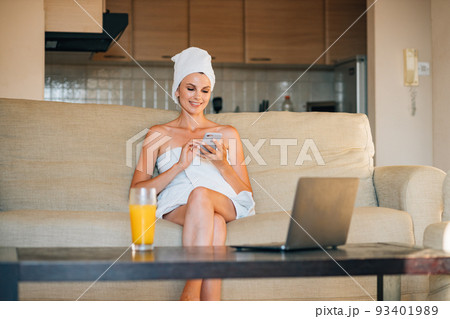 Young beautiful woman with smartphone having breakfast in bed. Young beautiful woman with smartphone having breakfast in bed. 93401989
