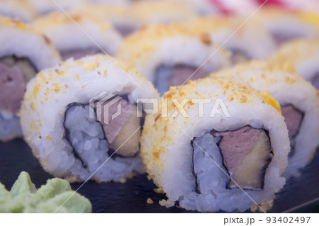 Assorted sushi food on a black slate plate Assorted sushi food on a black slate plate 93402497