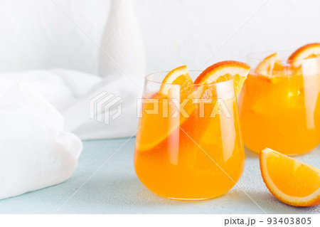 Hard seltzer refreshing orange cocktail in glasses on a table. Homemade drink. Copy space 93403805