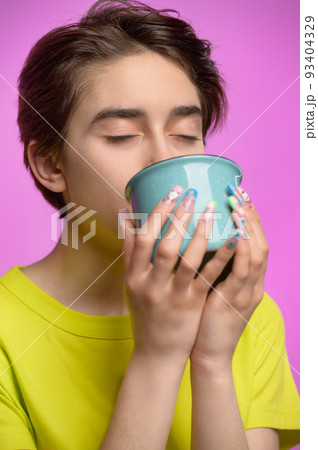 Bored young girl drinking from big cup of tea or coffee at morning 93404329