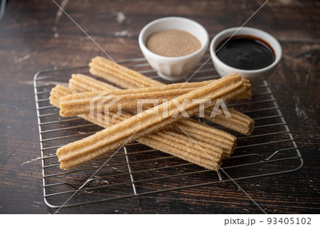 churros with chocolate sauce and cinnamon powder 93405102