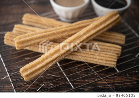churros with chocolate sauce and cinnamon powder 93405105